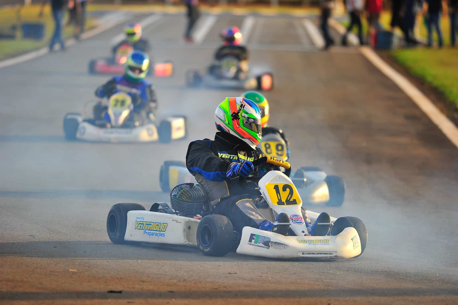 person riding on white and blue go kart