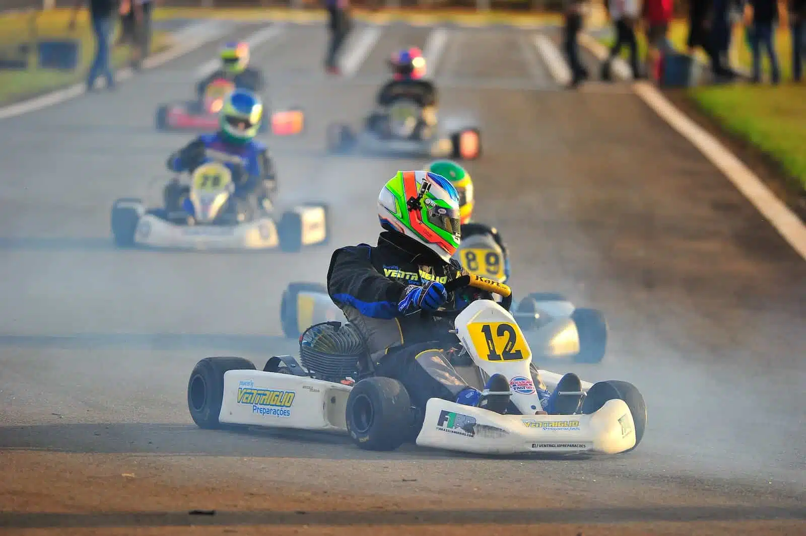 person riding on white and blue go kart